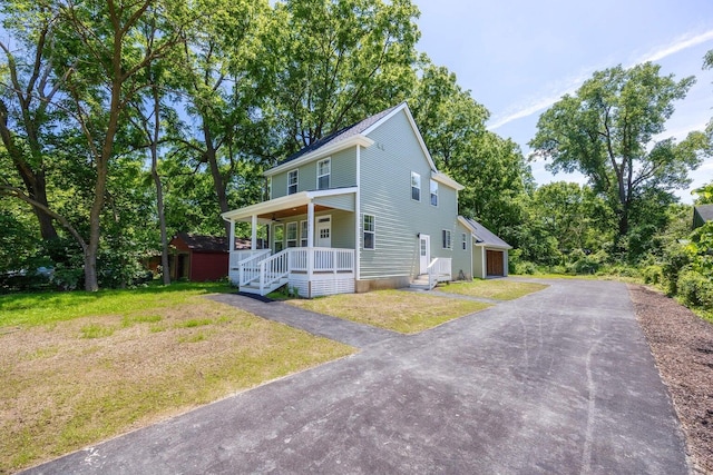 view of front of home with a porch and a front yard