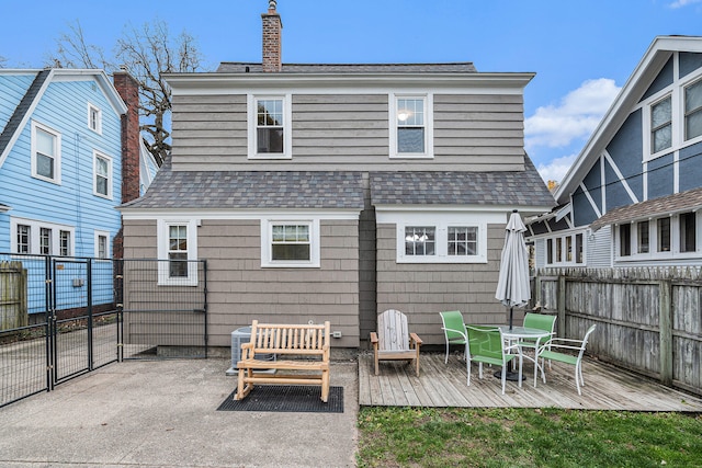 back of house featuring a wooden deck and cooling unit