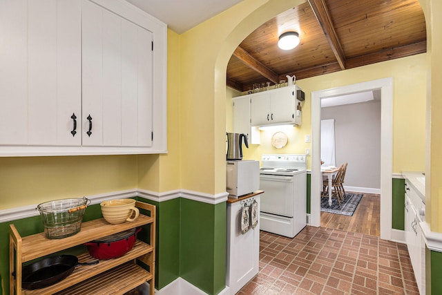 kitchen featuring beamed ceiling, white cabinets, wood ceiling, and white appliances