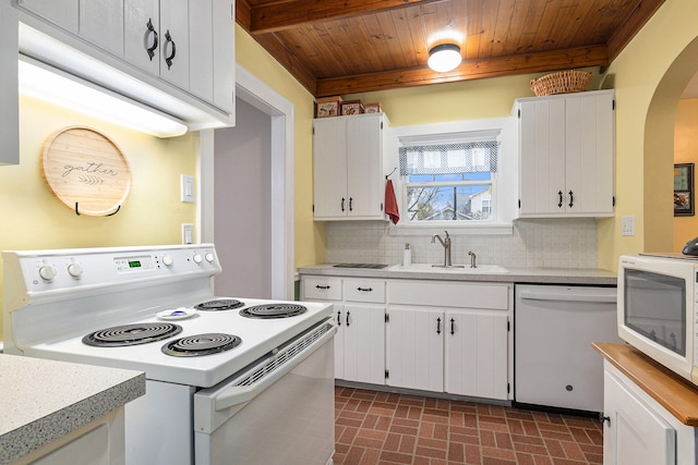 kitchen featuring white appliances, tasteful backsplash, white cabinetry, and sink