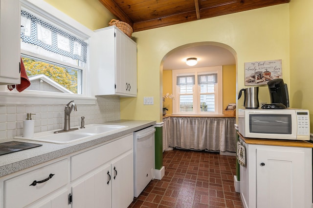 kitchen featuring sink, backsplash, white appliances, white cabinets, and wood ceiling