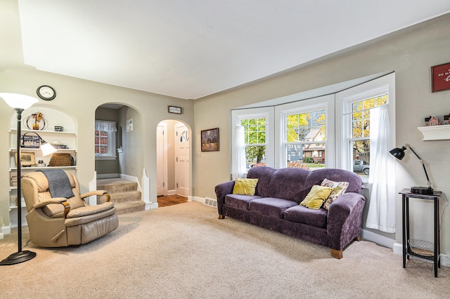 living room featuring built in features and carpet floors