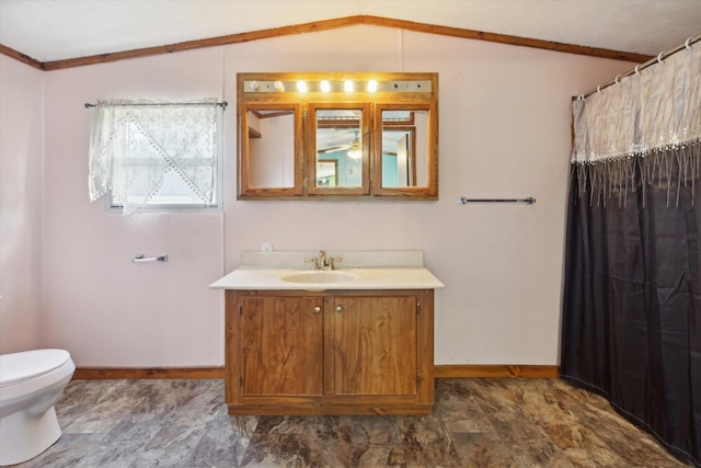 bathroom with crown molding, vanity, lofted ceiling, and toilet