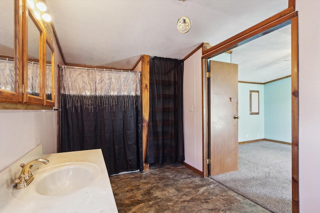 bathroom featuring crown molding and vanity