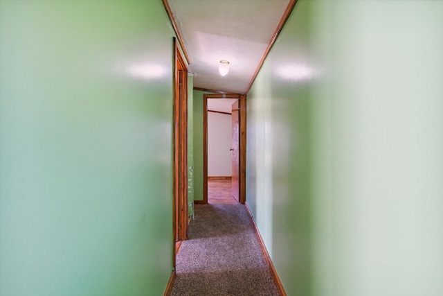 hall with carpet, a textured ceiling, vaulted ceiling, and ornamental molding