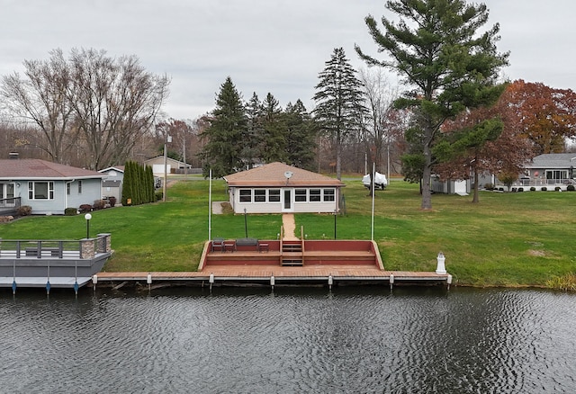 view of dock featuring a deck with water view and a yard