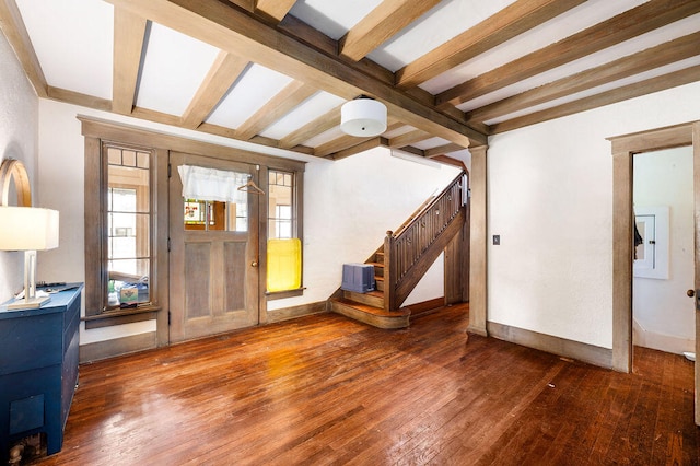 entryway with dark hardwood / wood-style flooring and beamed ceiling