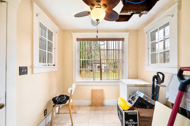 sunroom / solarium featuring a wealth of natural light and ceiling fan