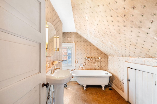 bathroom with a bathtub and vaulted ceiling