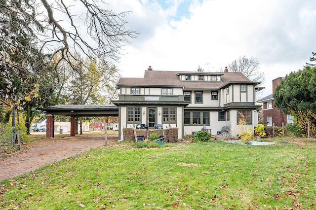 back of property featuring a yard and a carport