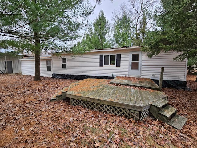 rear view of property featuring a deck