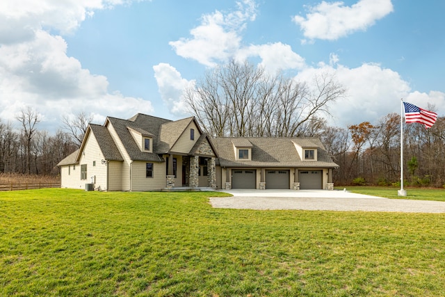 view of front of property featuring central AC unit, a garage, and a front lawn