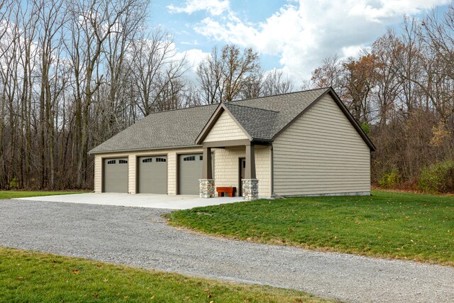 view of home's exterior with a garage and a lawn