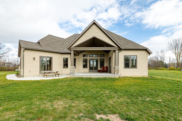 rear view of property with a yard and a patio