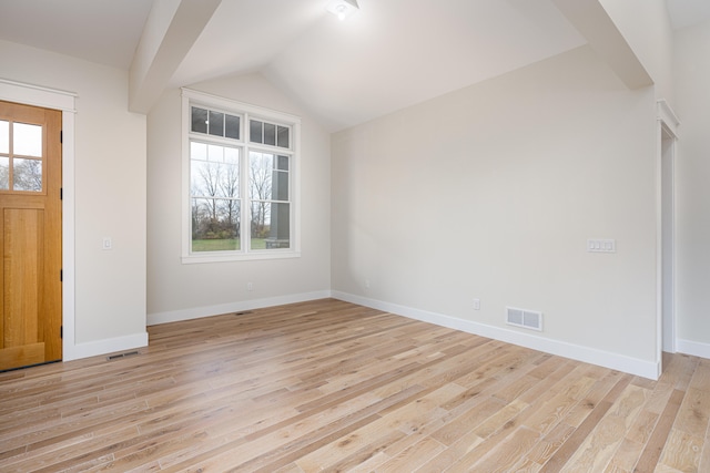 entryway featuring light hardwood / wood-style floors and vaulted ceiling