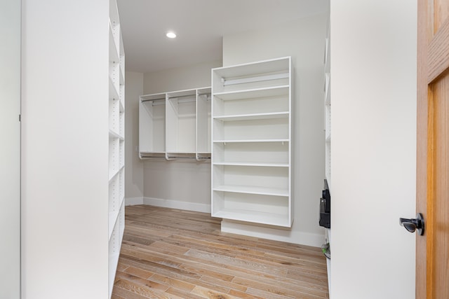 spacious closet with light hardwood / wood-style flooring