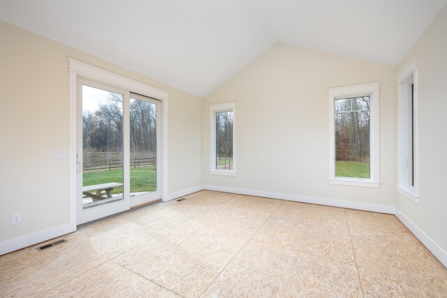 empty room featuring lofted ceiling