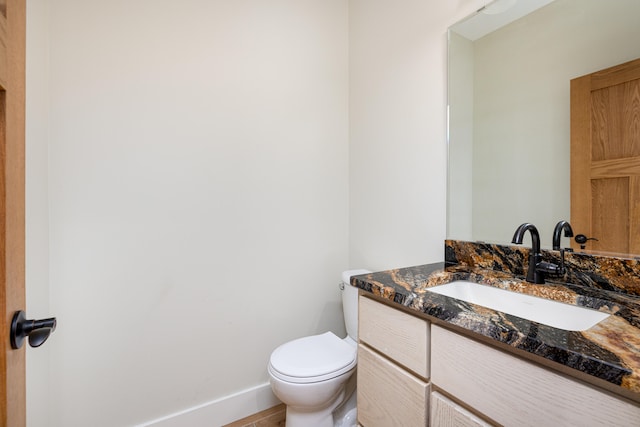 bathroom featuring tile patterned flooring, vanity, and toilet