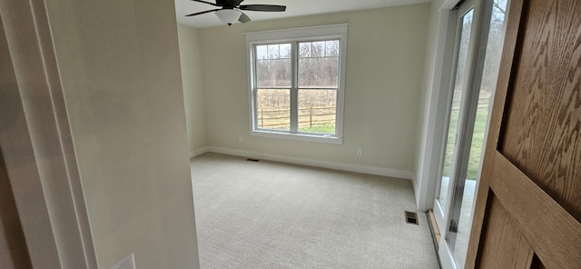 carpeted spare room with ceiling fan