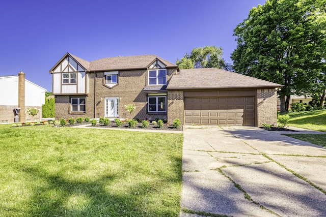 tudor home with a front yard and a garage