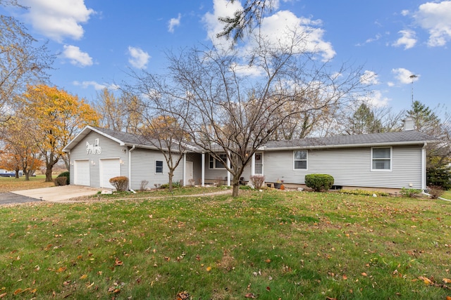 ranch-style house with a garage and a front lawn