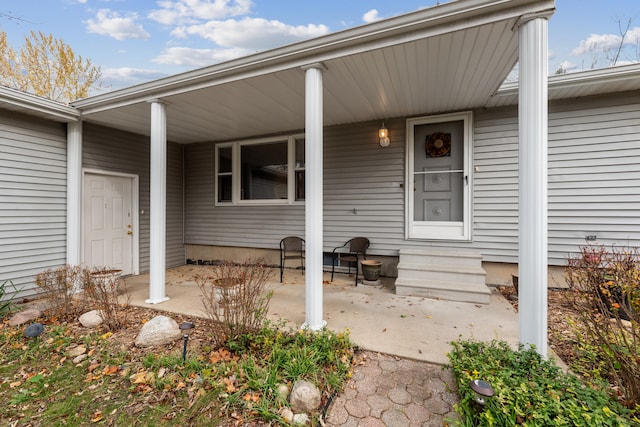 view of exterior entry featuring a porch