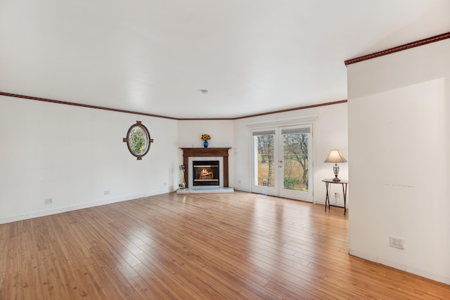 unfurnished living room featuring crown molding and light wood-type flooring