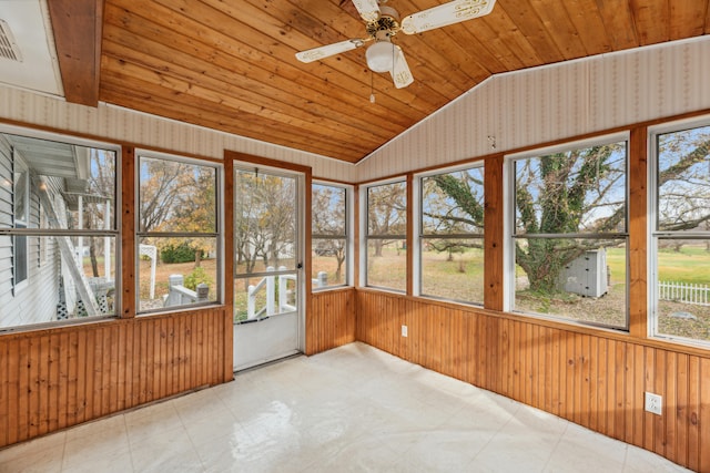 unfurnished sunroom featuring vaulted ceiling, ceiling fan, a healthy amount of sunlight, and wood ceiling