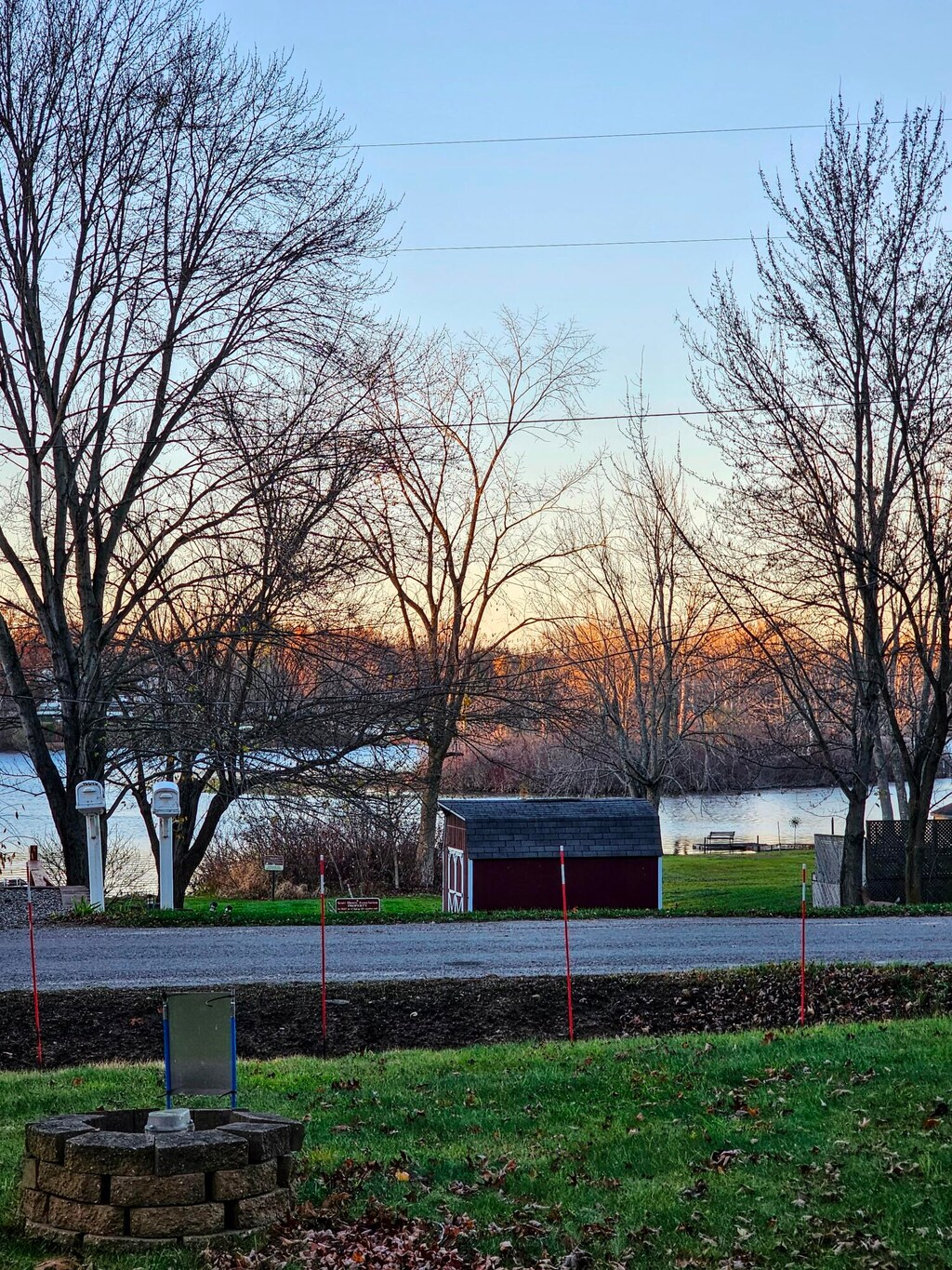 yard at dusk featuring a water view