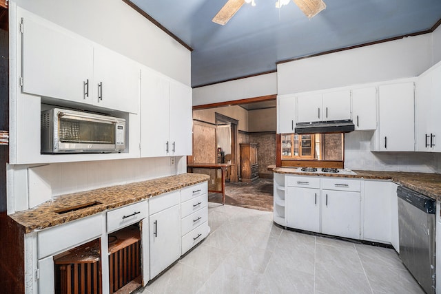 kitchen featuring white cabinetry, appliances with stainless steel finishes, dark stone countertops, ceiling fan, and decorative backsplash