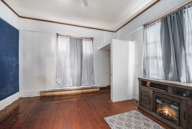 interior space with dark wood-type flooring, ceiling fan, a baseboard radiator, and ornamental molding