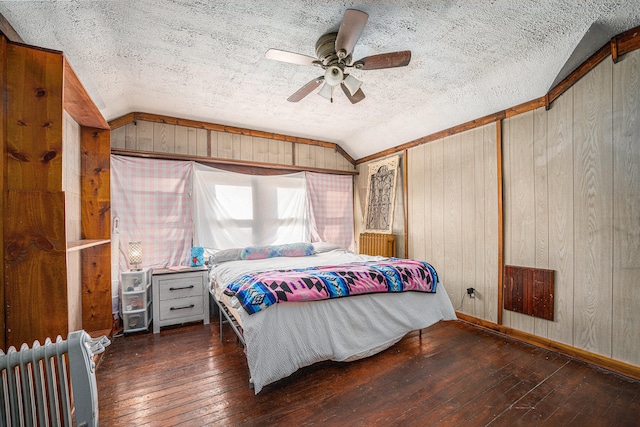 bedroom featuring dark hardwood / wood-style flooring, lofted ceiling, and radiator heating unit