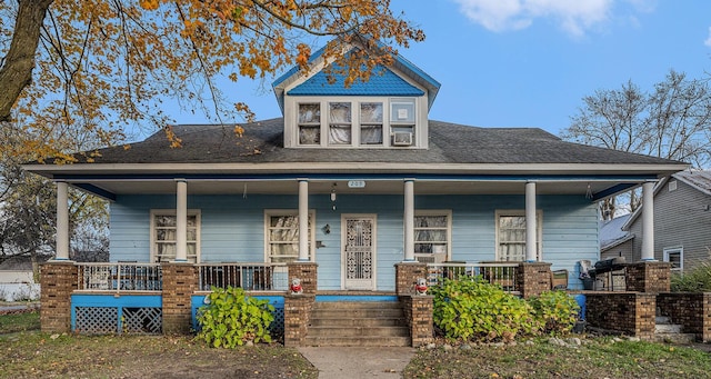 view of front of home featuring a porch and cooling unit