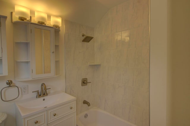 full bathroom with toilet, tiled shower / bath combo, and vanity