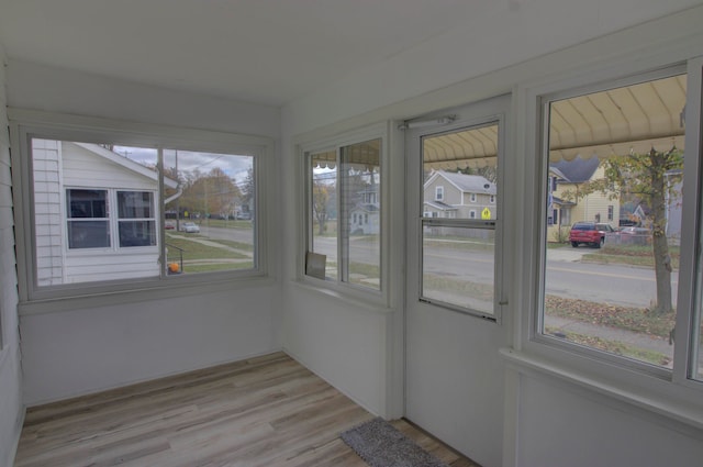 unfurnished sunroom with plenty of natural light