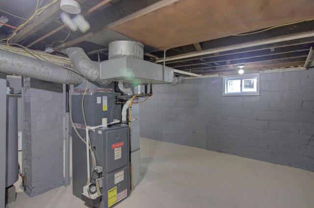 basement featuring heating unit and gas water heater