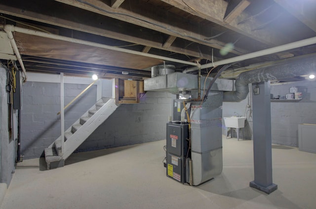 basement featuring heating unit and sink