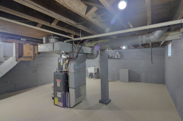 basement with heating unit and sink