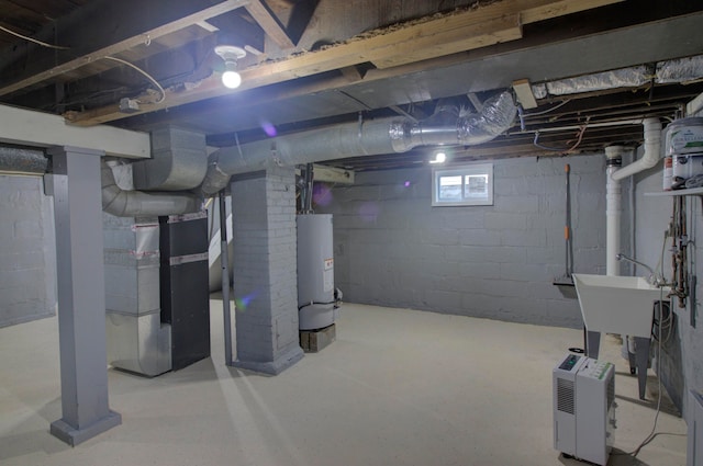 basement featuring heating unit, sink, and gas water heater