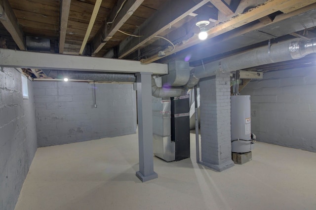 basement featuring gas water heater and heating unit