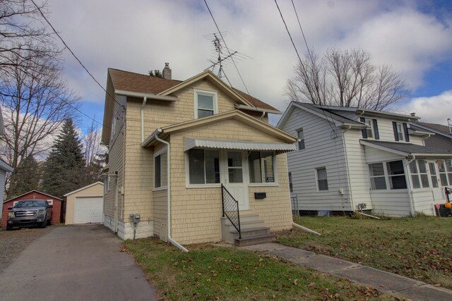 view of front of property with an outbuilding, a garage, and a front yard