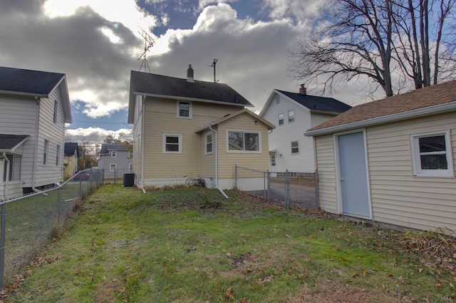 back of property with a lawn and cooling unit