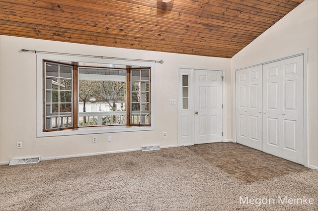 interior space with wood ceiling, lofted ceiling, and carpet floors