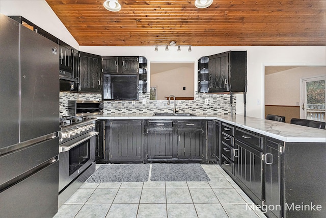 kitchen featuring appliances with stainless steel finishes, light tile patterned floors, sink, kitchen peninsula, and wooden ceiling