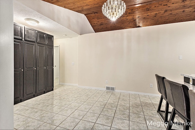 unfurnished dining area featuring a notable chandelier, lofted ceiling, light tile patterned flooring, and wooden ceiling