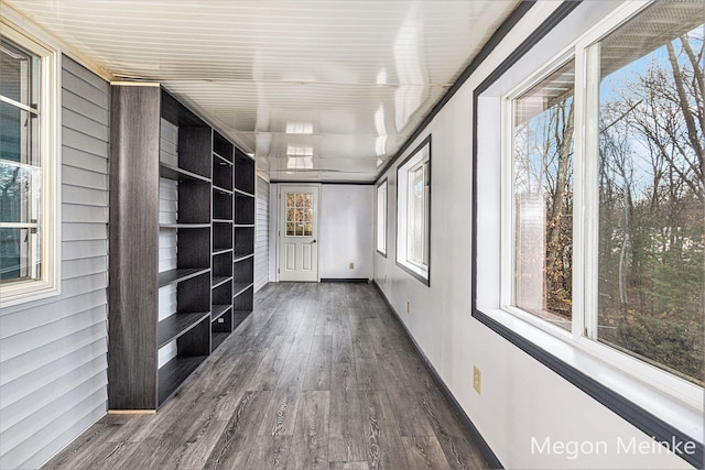 corridor with dark hardwood / wood-style floors