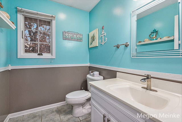 bathroom featuring vanity, tile patterned floors, and toilet