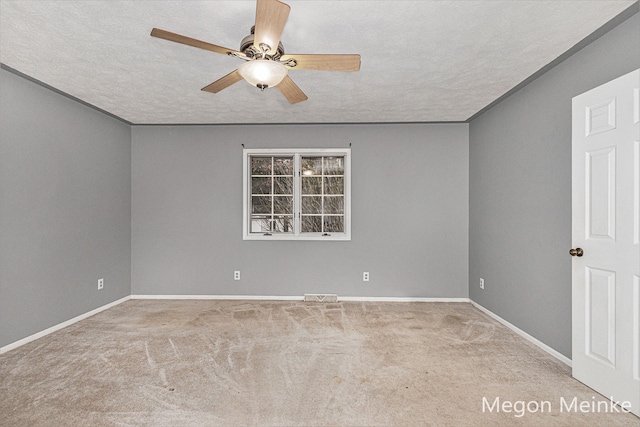 carpeted empty room with a textured ceiling and ceiling fan