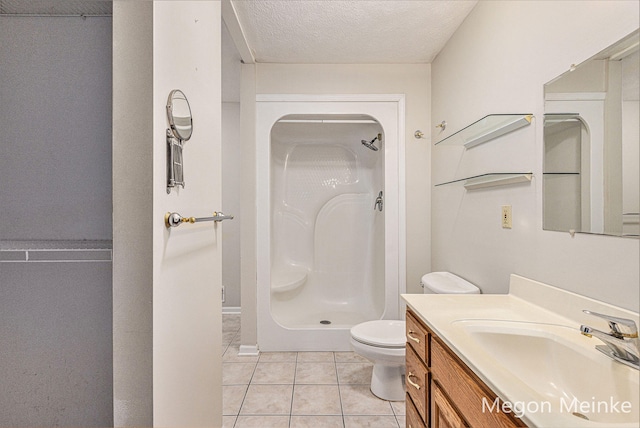 bathroom with tile patterned floors, walk in shower, vanity, a textured ceiling, and toilet