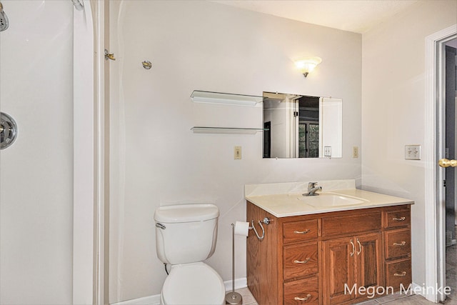 bathroom featuring tile patterned floors, vanity, and toilet